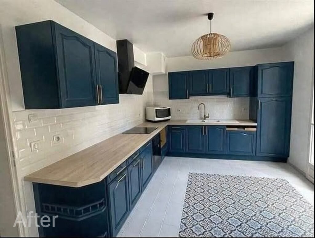 Modern navy blue shaker cabinets with light wood countertops, white subway tile backsplash, black range hood, and woven pendant light in kitchen remodel Salt Lake City
